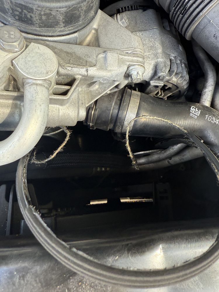Close-up view underneath a vehicle showing the exhaust pipe and suspension components.